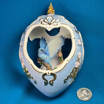 ORNATE CERAMIC OPENWORK EGG WITH BIRD ON BRANCH INSIDE, GOLD PAINTED TRIM
