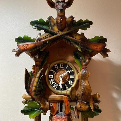 Black Forest cuckoo, clock with guns and animals