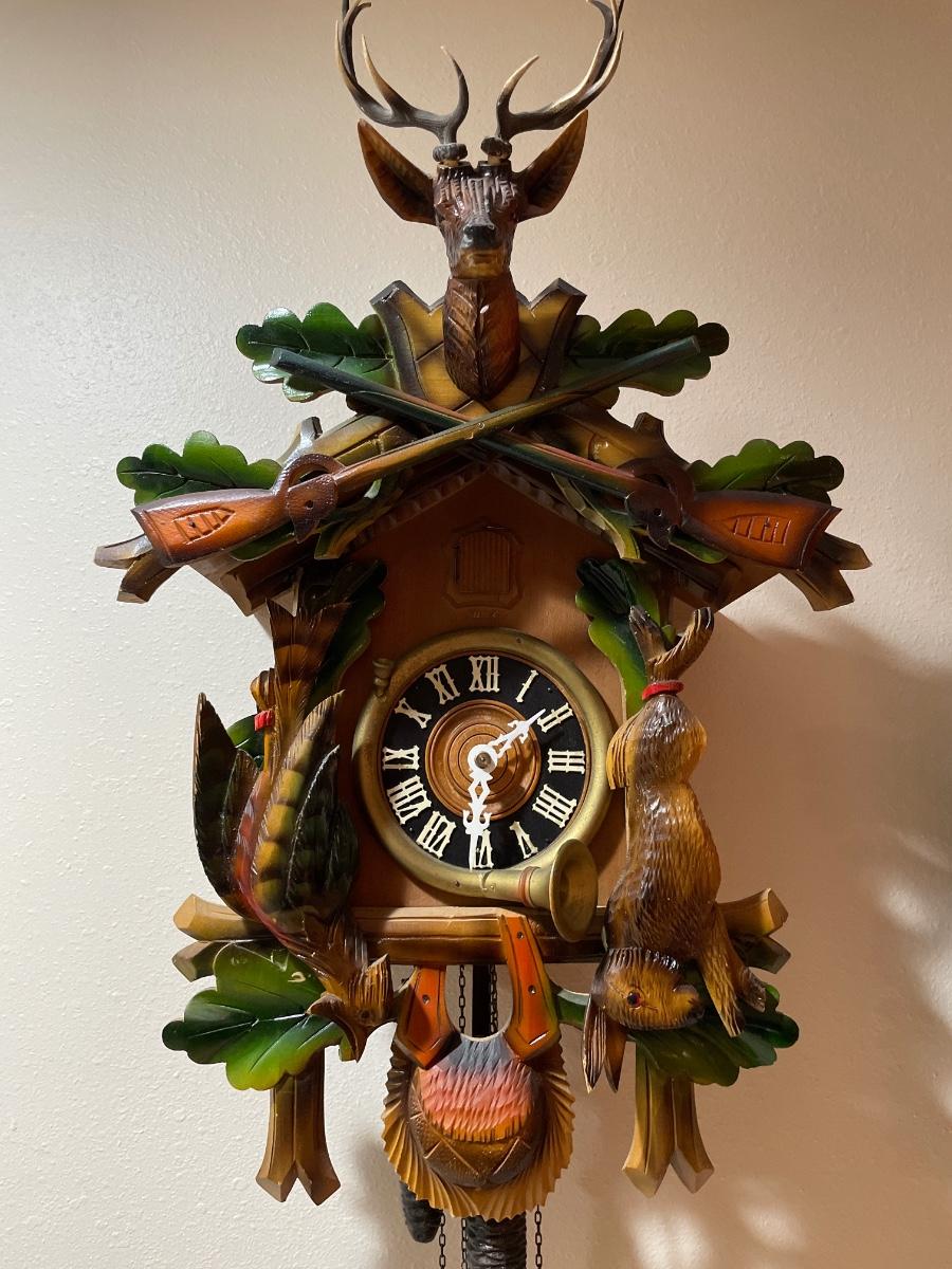 Black Forest cuckoo, clock with guns and animals | EstateSales.org