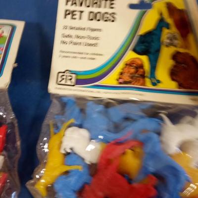 LOT 142 TWO BAGS OF PLASTIC TOY DOGS AND DOLLS