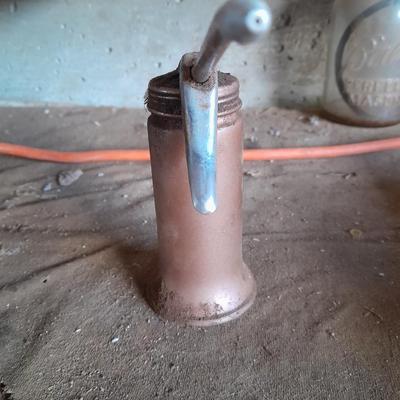 Copper colored oil can
