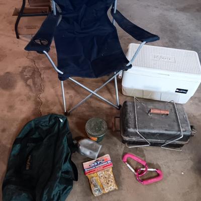 Folding camp chair, Cooler, Grill, and an assortment of other camping items