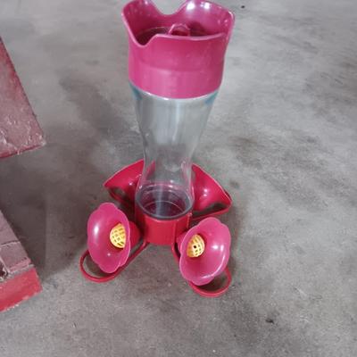 Wooden handmade bird feeder and a Glass globed hummingbird feeder.