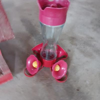 Wooden handmade bird feeder and a Glass globed hummingbird feeder.