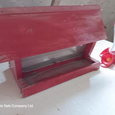 Wooden handmade bird feeder and a Glass globed hummingbird feeder.