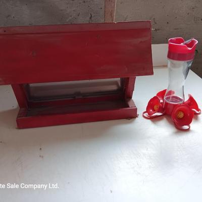 Wooden handmade bird feeder and a Glass globed hummingbird feeder.