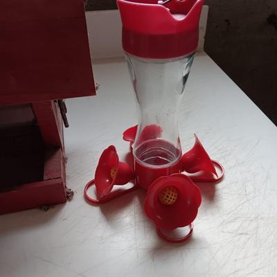 Wooden handmade bird feeder and a Glass globed hummingbird feeder.