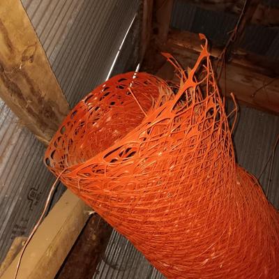 Four rolls of orange construction barrier fencing