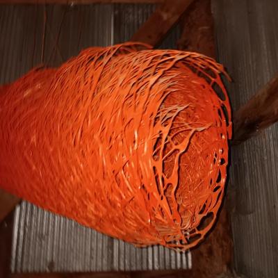 Four rolls of orange construction barrier fencing