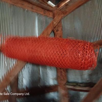 Four rolls of orange construction barrier fencing
