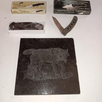 Lasered art tile with wolf and two new pocketknives