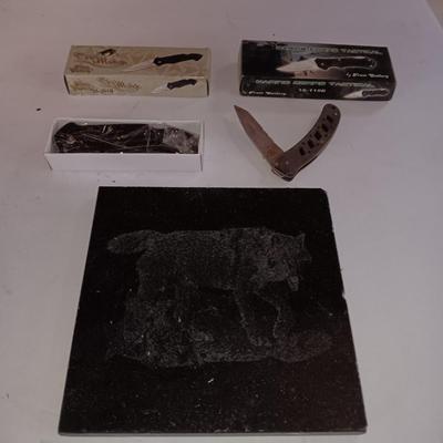 Lasered art tile with wolf and two new pocketknives