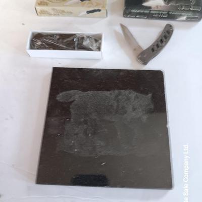Lasered art tile with wolf and two new pocketknives