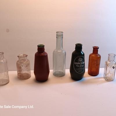 Vintage glass bottles and crock like bottles