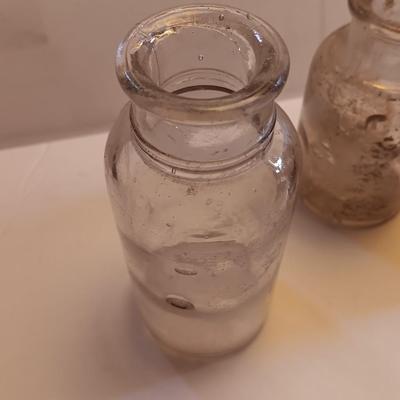 Vintage glass bottles and crock like bottles