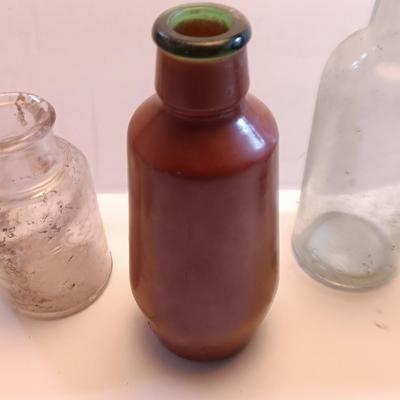 Vintage glass bottles and crock like bottles
