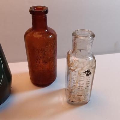 Vintage glass bottles and crock like bottles