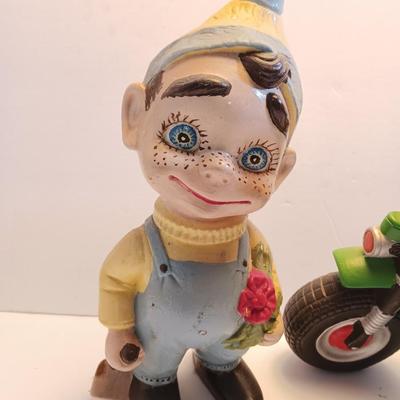 Vintage Atlantic Mold company Boy on motorbike and boy planting flowers