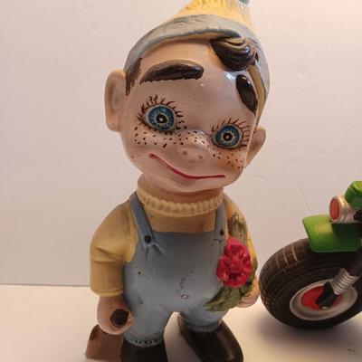 Vintage Atlantic Mold company Boy on motorbike and boy planting flowers
