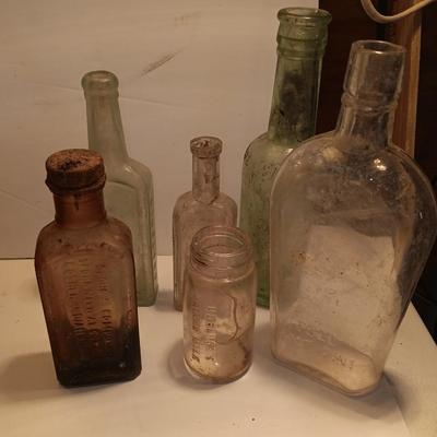 Antique wooden box with two metal boxes some old bottles and a vintage hay hook