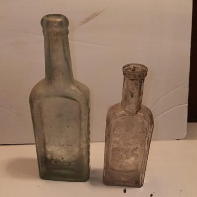 Antique wooden box with two metal boxes some old bottles and a vintage hay hook