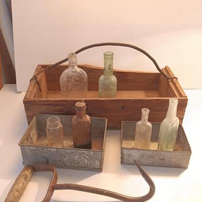 Antique wooden box with two metal boxes some old bottles and a vintage hay hook