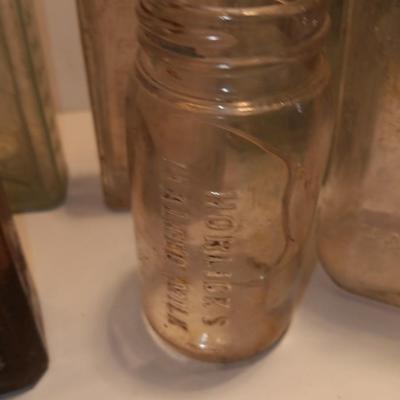 Antique wooden box with two metal boxes some old bottles and a vintage hay hook