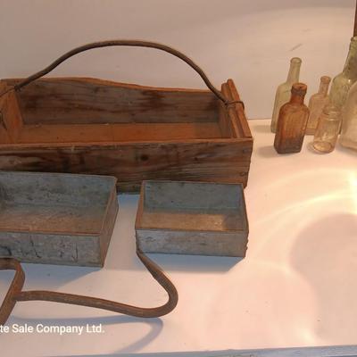 Antique wooden box with two metal boxes some old bottles and a vintage hay hook