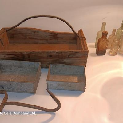 Antique wooden box with two metal boxes some old bottles and a vintage hay hook