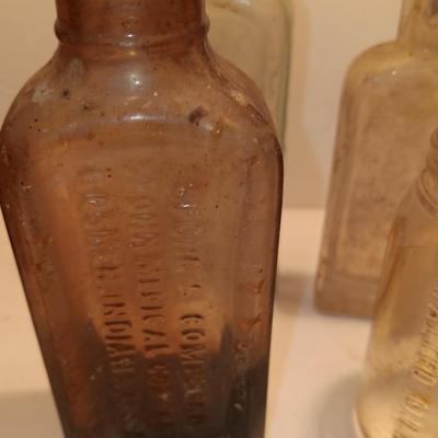 Antique wooden box with two metal boxes some old bottles and a vintage hay hook