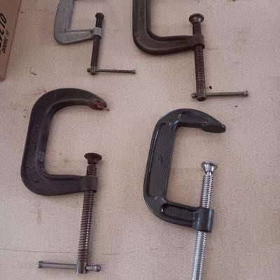 Four metal T handled clamps