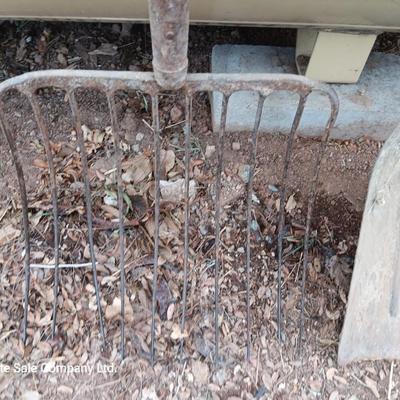 Vintage scoop shovel with antique pitch fork