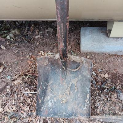 Two shovels and a vintage pickaxe