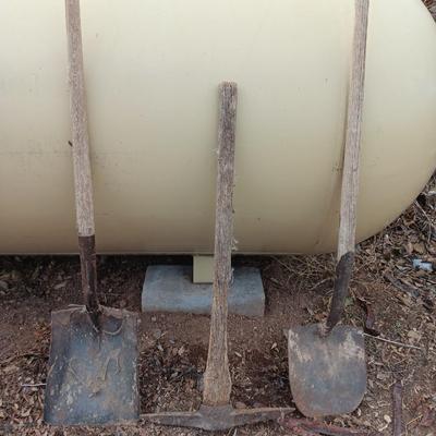 Two shovels and a vintage pickaxe