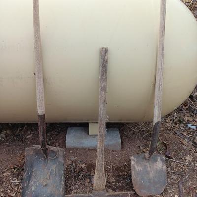 Two shovels and a vintage pickaxe