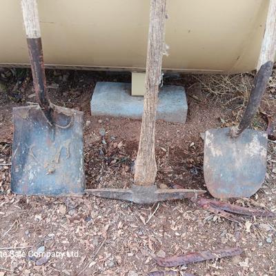 Two shovels and a vintage pickaxe