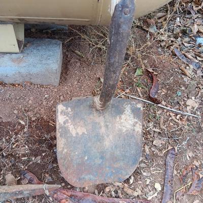 Two shovels and a vintage pickaxe