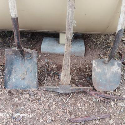 Two shovels and a vintage pickaxe