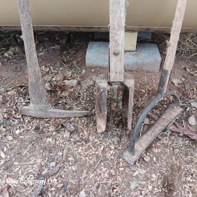 Vintage hand tools - post hole diggers = pickaxe and scythe