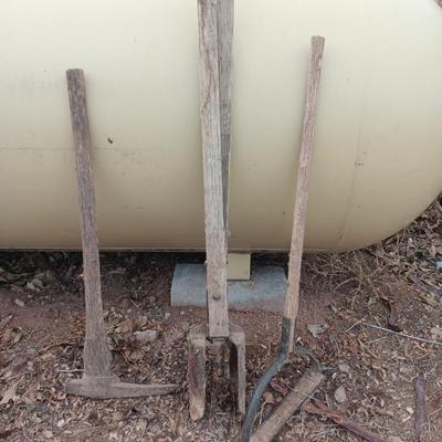 Vintage hand tools - post hole diggers = pickaxe and scythe