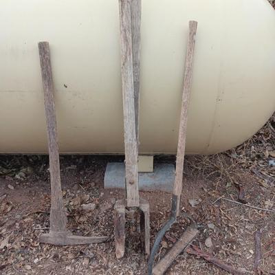 Vintage hand tools - post hole diggers = pickaxe and scythe