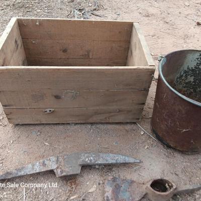 Wooden crate with Pickaxe heads and a rusty feed bucket
