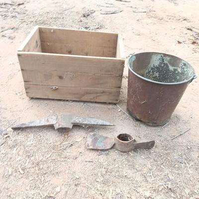 Wooden crate with Pickaxe heads and a rusty feed bucket