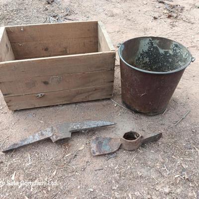 Wooden crate with Pickaxe heads and a rusty feed bucket
