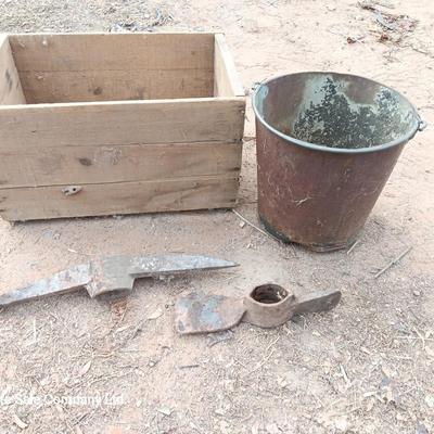 Wooden crate with Pickaxe heads and a rusty feed bucket