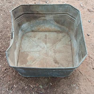 Metal wash tub with two vintage pickaxe heads