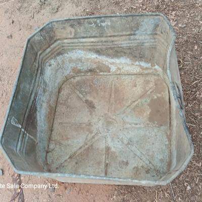 Metal wash tub with two vintage pickaxe heads