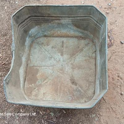 Metal wash tub with two vintage pickaxe heads
