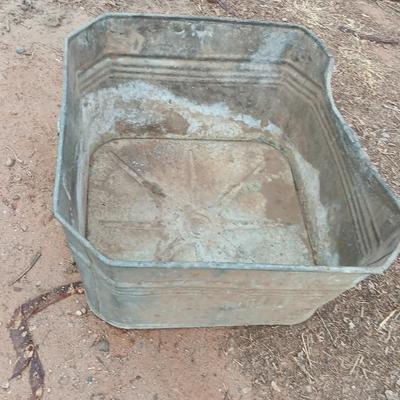 Metal wash tub with two vintage pickaxe heads