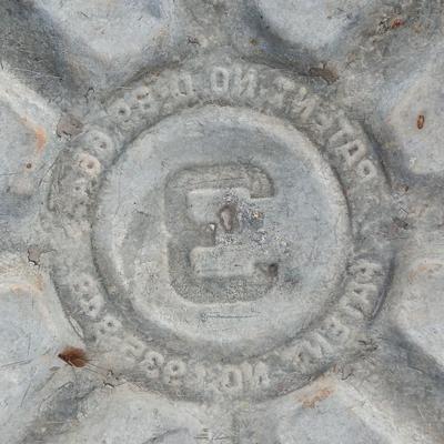 Metal wash tub with two vintage pickaxe heads